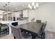 Open-concept kitchen with modern white cabinets, an island with barstools, and a dining table at 1077 Hearth Sw Ln, Concord, NC 28025