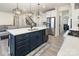 Bright kitchen features pendant lighting, stainless steel appliances, and an island with quartz countertops at 1077 Hearth Sw Ln, Concord, NC 28025
