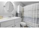 Functional bathroom featuring a white vanity, round mirror, and cabinet storage at 1158 Waterford Dr, Hickory, NC 28602