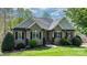 Charming brick home with manicured lawn, tasteful landscaping, and classic architectural details at 1158 Waterford Dr, Hickory, NC 28602