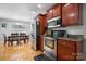 Kitchen with stainless steel appliances, wood cabinets, hardwood flooring, and a dining area at 1158 Waterford Dr, Hickory, NC 28602
