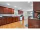 Well-lit kitchen with wood cabinets, granite countertops, hardwood floors, and stainless steel appliances at 1158 Waterford Dr, Hickory, NC 28602