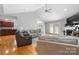 Open living room with a fireplace, vaulted ceilings, hardwood floors, and an open floor plan at 1158 Waterford Dr, Hickory, NC 28602