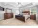Spacious main bedroom with a ceiling fan, tray ceiling, and plenty of natural light at 1158 Waterford Dr, Hickory, NC 28602