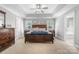 Spacious main bedroom with a ceiling fan, tray ceiling, and plenty of natural light at 1158 Waterford Dr, Hickory, NC 28602