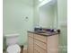 Stylish powder room features a vanity with granite countertop and modern fixtures at 1158 Waterford Dr, Hickory, NC 28602