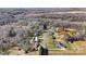Expansive aerial view of a home nestled among trees with sheds and open land at 119 Loray Ln, Statesville, NC 28625