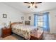 Comfortable bedroom featuring a floral comforter, wooden chest, and cozy window with blue curtains at 119 Loray Ln, Statesville, NC 28625