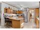 Inviting kitchen with wood cabinetry, breakfast bar, and stainless steel appliances at 119 Loray Ln, Statesville, NC 28625