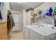 Functional laundry room equipped with washer, dryer, storage shelves, and exterior access for convenience at 119 Loray Ln, Statesville, NC 28625