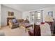 Spacious living room with floral sofa, red chair, and ample natural light creating a welcoming area at 119 Loray Ln, Statesville, NC 28625