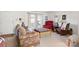 Comfortable living room with patterned sofa and ottoman near windows, showcasing a relaxed setting at 119 Loray Ln, Statesville, NC 28625