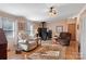 Cozy living room featuring a wood-burning stove and comfortable seating area with a ceiling fan at 119 Loray Ln, Statesville, NC 28625