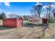 Outbuildings with an overhead garage and storage shed, offering functionality and ample space at 119 Loray Ln, Statesville, NC 28625