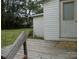 Deck with stairs leads to the house's back door and is surrounded by trees at 1230 Roberts St, China Grove, NC 28023