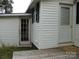 View of back of house with access to two doors and a window with black shutters at 1230 Roberts St, China Grove, NC 28023