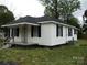 Traditional home with a covered porch and black shutters adding character and curb appeal at 1230 Roberts St, China Grove, NC 28023