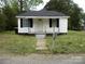 Charming single-story home with a welcoming front yard and black shutters on a partially cloudy day at 1230 Roberts St, China Grove, NC 28023