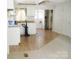 Bright eat-in kitchen with white cabinets, wood countertop, and a seamless transition to an adjacent carpeted room at 1230 Roberts St, China Grove, NC 28023