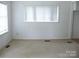 Bright, airy living room featuring carpet, a large window and white walls for a clean, neutral feel at 1230 Roberts St, China Grove, NC 28023