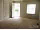 Inviting living room featuring carpet and transition flooring to an adjacent space at 1230 Roberts St, China Grove, NC 28023