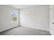 Bright bedroom with plush gray carpeting and a large window for natural light at 1240 Morehead Dr, Salisbury, NC 28144