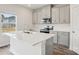 Charming kitchen with gray cabinets, island with white countertop, stainless appliances and wood flooring at 1240 Morehead Dr, Salisbury, NC 28144