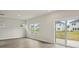 Bright living room with sliding glass door, three windows, and modern flooring at 1240 Morehead Dr, Salisbury, NC 28144
