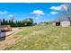 Expansive backyard with a shed, fire pit, wooden deck, and green grass at 126 Top Flite Dr, Statesville, NC 28677
