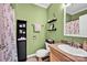 Cozy bathroom featuring green walls, a black shelving unit, and decorative details at 126 Top Flite Dr, Statesville, NC 28677