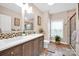 Bathroom boasting double sinks, wooden cabinets, and a tiled shower at 126 Top Flite Dr, Statesville, NC 28677