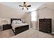 Neutral bedroom featuring dark furniture, a ceiling fan and window with natural light at 126 Top Flite Dr, Statesville, NC 28677