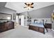 The bedroom features a dark bed frame, carpet, a ceiling fan, and neutral paint at 126 Top Flite Dr, Statesville, NC 28677