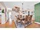 Elegant dining room featuring a large wooden table, hardwood floors, and stylish decor at 126 Top Flite Dr, Statesville, NC 28677