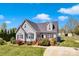 Attractive home with gray siding, a dark roof, and a beautifully landscaped front yard at 126 Top Flite Dr, Statesville, NC 28677
