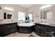 Bright bathroom features dual vanities and a garden tub, creating a spa-like atmosphere for relaxation at 126 Top Flite Dr, Statesville, NC 28677