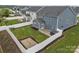 Aerial view of a blue home with an enclosed backyard, patio, and green lawn at 12710 Es Draper Dr, Huntersville, NC 28078