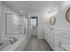 Bright bathroom featuring double vanity, tiled shower, soaking tub, and natural light at 12710 Es Draper Dr, Huntersville, NC 28078