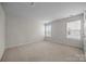 Spacious bedroom with neutral carpet, light walls, and two windows at 12710 Es Draper Dr, Huntersville, NC 28078