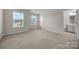 Bedroom with neutral carpet, light walls, and an attached bathroom at 12710 Es Draper Dr, Huntersville, NC 28078