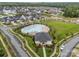Aerial view of a sparkling community pool with ample seating and a modern clubhouse surrounded by lush landscaping at 12710 Es Draper Dr, Huntersville, NC 28078