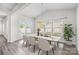 Bright dining room with vaulted ceilings, modern lighting, and access to the backyard at 12710 Es Draper Dr, Huntersville, NC 28078