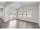 Bright dining room featuring three windows, a French door and modern chandelier at 12710 Es Draper Dr, Huntersville, NC 28078