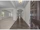 Inviting foyer with hardwood floors, elegant archways, and a view of the living and dining areas at 12710 Es Draper Dr, Huntersville, NC 28078