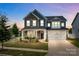 Beautiful two-story home with stone accents, a well-manicured lawn, and a two-car garage in a lovely neighborhood at 12710 Es Draper Dr, Huntersville, NC 28078