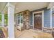 Inviting front porch with stone accents and comfortable seating area at 12710 Es Draper Dr, Huntersville, NC 28078