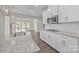 Modern kitchen featuring white cabinets, granite countertops, gold hardware and stainless steel appliances at 12710 Es Draper Dr, Huntersville, NC 28078