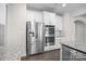 Kitchen with stainless steel refrigerator and built-in double ovens, accented by granite countertops at 12710 Es Draper Dr, Huntersville, NC 28078