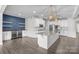 Open kitchen with stainless steel appliances, granite countertops, wine cooler and modern lighting at 12710 Es Draper Dr, Huntersville, NC 28078