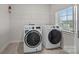 Laundry room with front-loading washer and dryer and wire shelving at 12710 Es Draper Dr, Huntersville, NC 28078